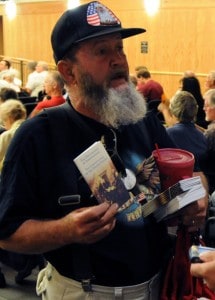 Harvey Baldwin, a member of Las Cruces TEA (Taxed Enough Already!) Party, handed out copies of the Declaration of Independence and Constitution before the meeting. (Photo by Heath Haussamen)