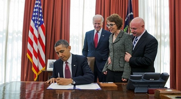 President Obama signs the Ultralight Aircraft Smuggling Prevention Act into law, accompanied by Rep. Gabrielle Giffords, sponsor of the legislation in the House.