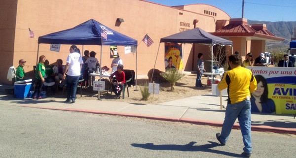 Various campaigns working to win voters near a polling place in Sunland Park earlier today.