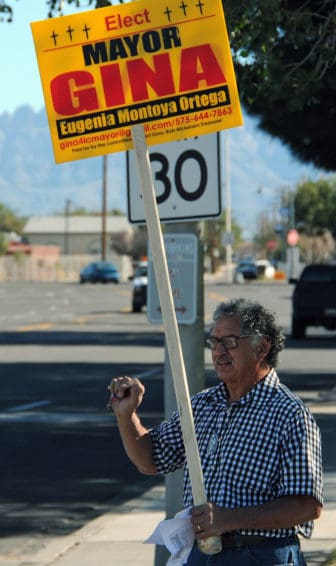 Francisco Olivas stood on the corner of Main Street and Picacho Avenue holding up a sign promoting mayoral candidate Gina Montoya-Ortega.